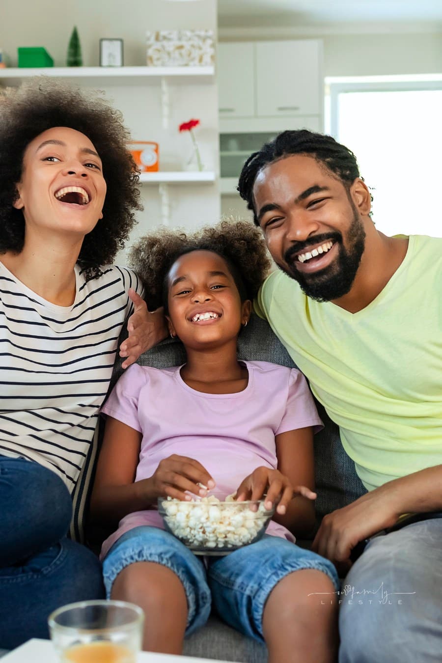 famil,y of three laughing during unplugged game night