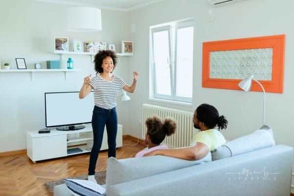 family of three playing Charades indoors